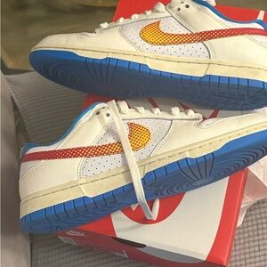 Nike White Sneakers with Blue Soles and Orange-Red Swoosh